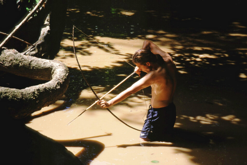 Matthew Simpson hunts in a river in Guyana during a work trip to study illegal mining's impacts on wetlands, including rivers. Credit: Courtesy of Matthew Simpson