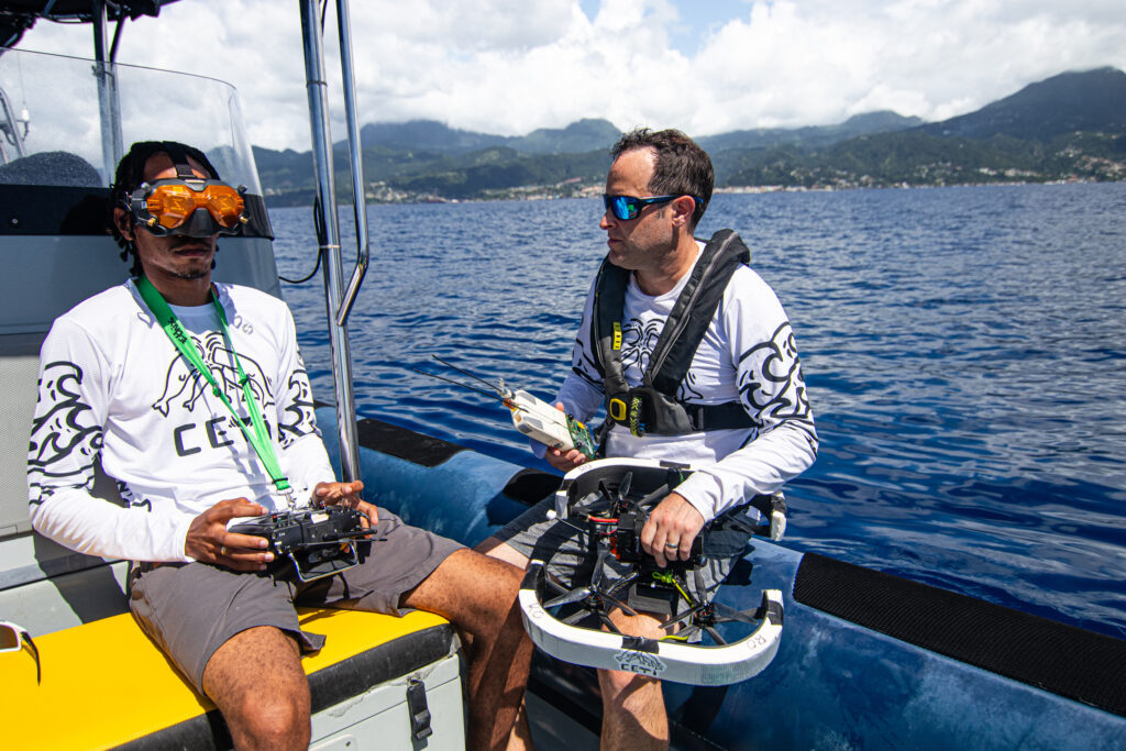 Drone pilot Zahrek Gonzalez-Peltier and Shane Gero, National Geographic Explorer and biology lead for Project CETI, prepare the novel CETI tag and drone for deployment. Credit: Michael Lees/National Geographic