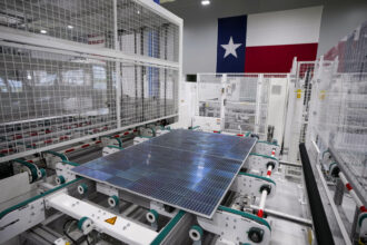 In Houston, solar panels run down the line to the next manufacturing process at Elin Energy's solar panel manufacturing facility. Credit: Brett Coomer/Houston Chronicle via Getty Images
