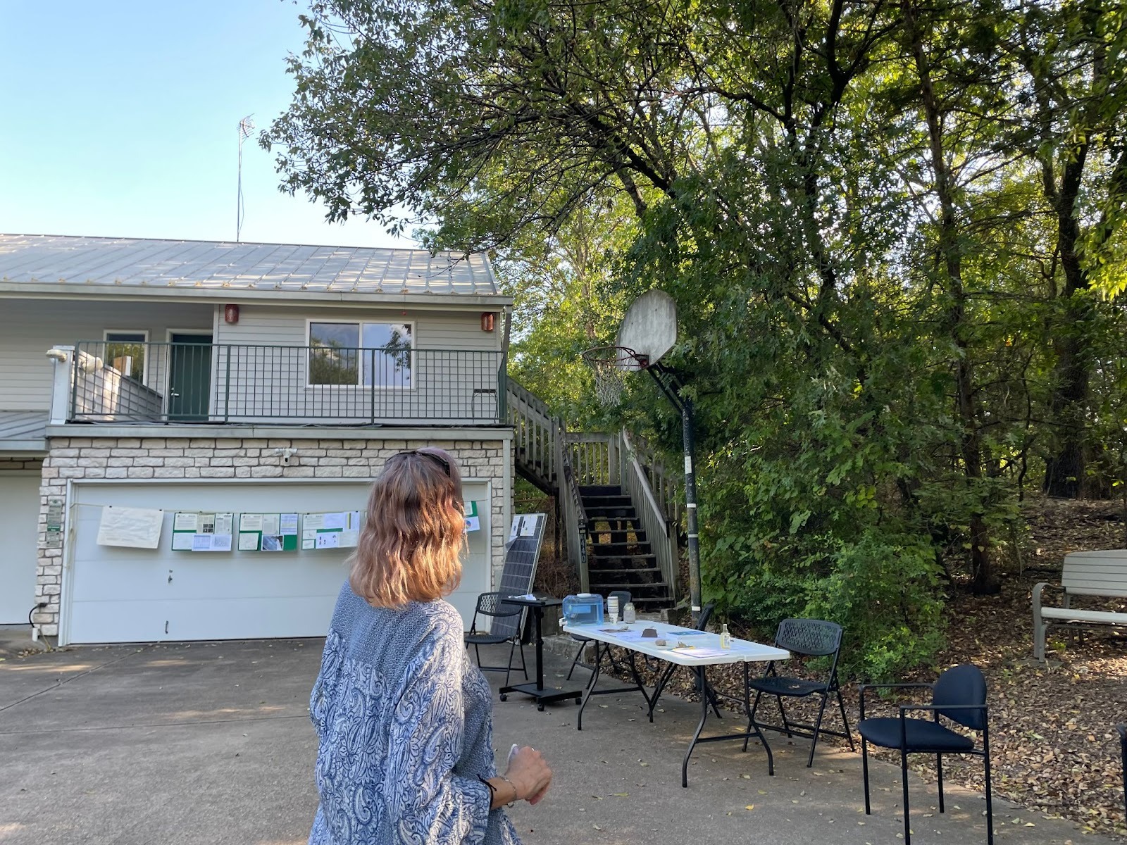 Elena Westbrook looks out at the tall trees surrounding the home she and her husband Paul Westbrook designed. Credit: Arcelia Martin/Inside Climate News