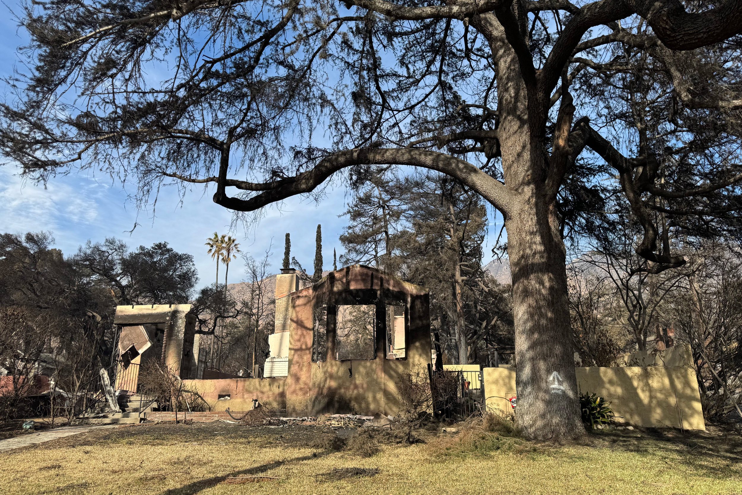 It’s hard to know exactly where and how this Altadena home caught fire, but darkness at the base of the wall shows that vegetation in zone zero ignited, releasing heat and smoke. Credit: Courtesy of Yana Valachovic