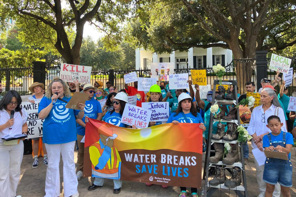 Members of the Workers Defense Project rally at the Texas Governor’s Mansion in 2023 to protest HB2127 and advocate for water breaks. Credit: Courtesy of Workers Defense Project