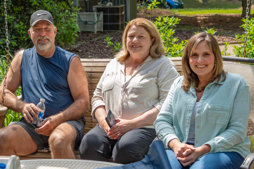 Mary Rosenboom (right) sits with her neighbors Ron and Becky Morgan. They all oppose a hyperscale data center proposed to be built in their backyards. Credit: Lee Hedgepeth/Inside Climate News