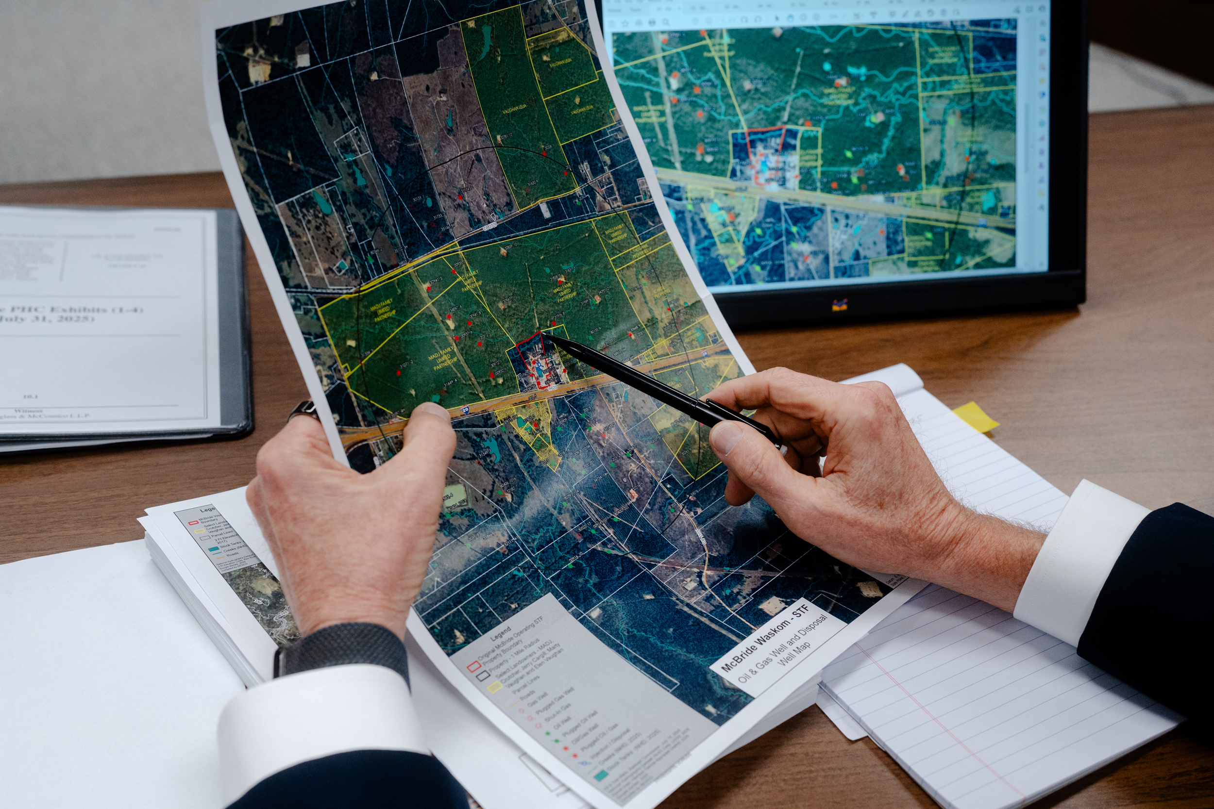 George Neale, an attorney representing Waskom resident Jerry Cargill, points to a map showing the site of a waste pit operated by McBride that was presented as evidence at a hearing of the Railroad Commission of Texas in Austin on July 31.