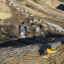 An aerial view of trucks unloading and spreading trash over a hill at the Chiquita Canyon Landfill in Castaic, Calif., in February 2024. Credit: Allen J. Schaben/Los Angeles Times via Getty Images