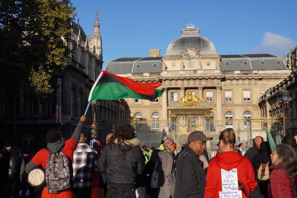 Protesters gather outside a Paris courthouse in October 2024 to support victims of chlordecone after judges dismissed a lawsuit filed 18 years ago.  Credit: Mathilde Augustin/Inside Climate News