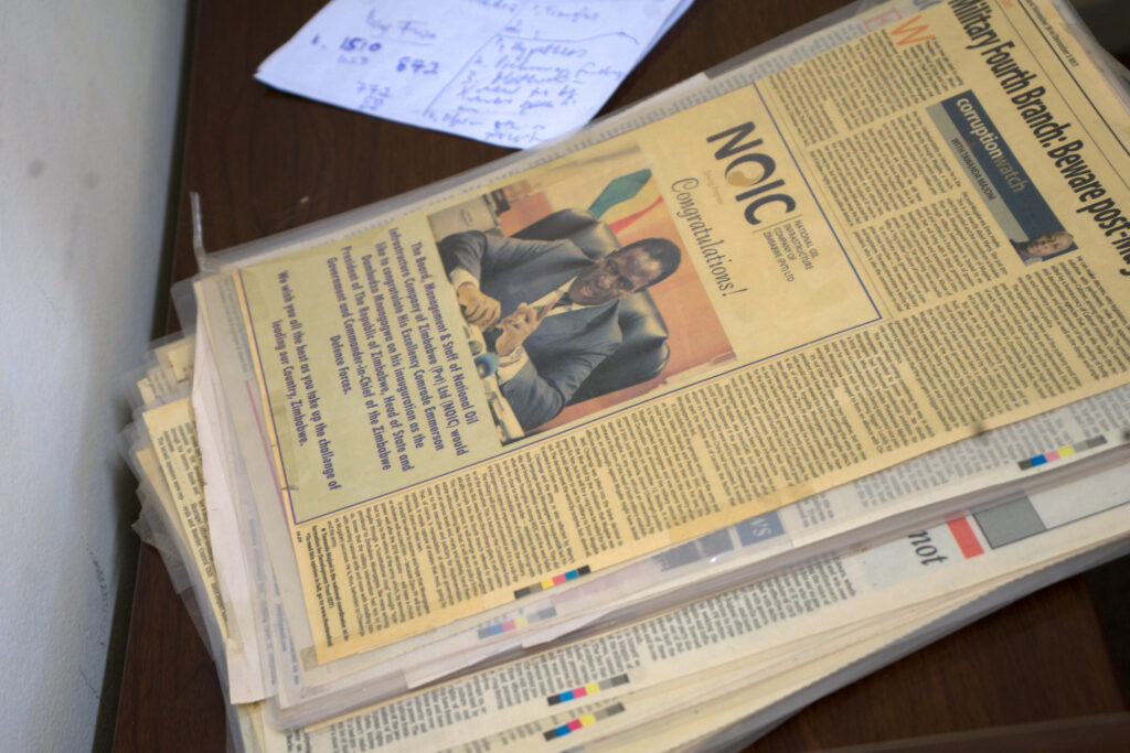 A stack of Tawanda Majoni’s laminated newspaper articles sits in his office. In Zimbabwe, news reports are sometimes pulled offline under pressure from powerful sources. Credit: Katie Surma/Inside Climate News