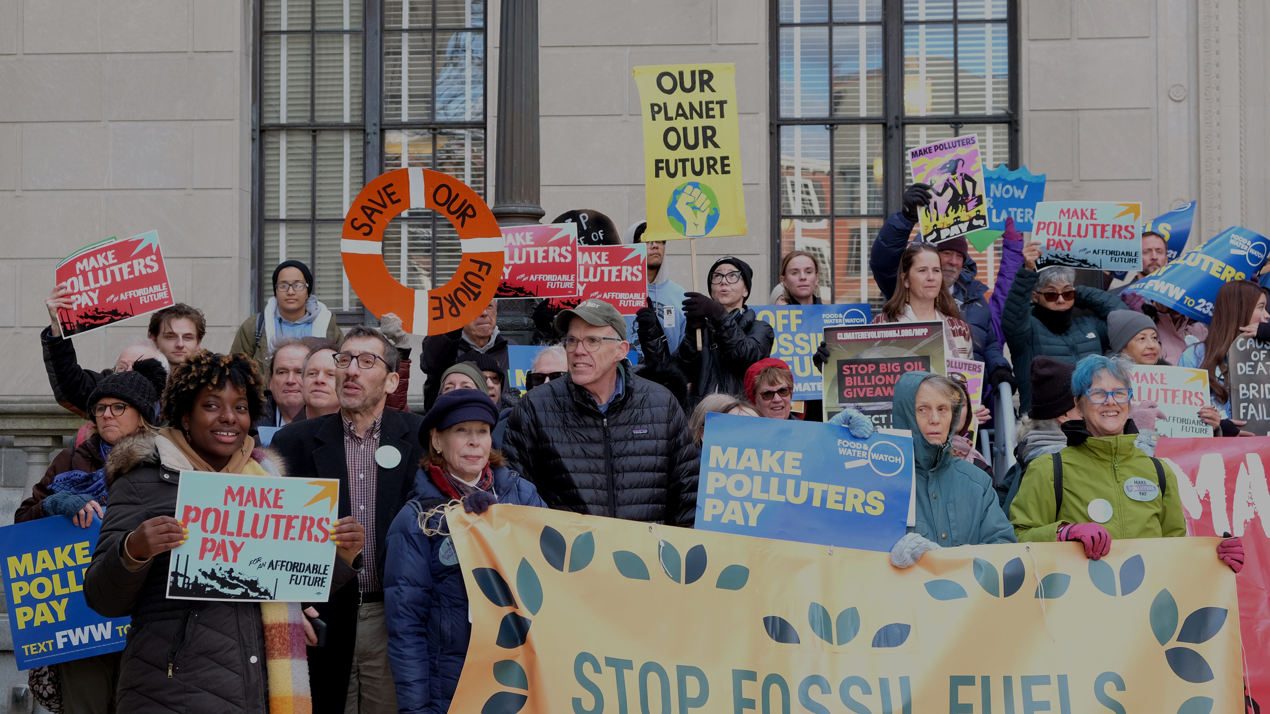 Bill McKibben (center-left) stands with the crowd gathered in front of the New Jersey state house in support of the Climate Superfund Act on Monday. Credit: Carrie Klein/Inside Climate News