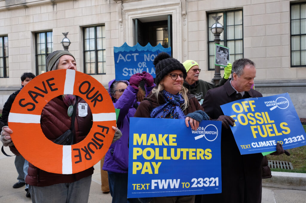 Activists with the group Food and Water Watch, a sponsor of Monday’s rally, hold signs reading “Make Polluters Pay!” Credit: Carrie Klein/Inside Climate News