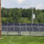 Solar panels are seen on the campus of Central Columbia High School in Bloomsburg, Pa., as part of a combination ground-mount and rooftop 3.8 megawatt array. Credit: Paul Weaver/SOPA Images/LightRocket via Getty Images
