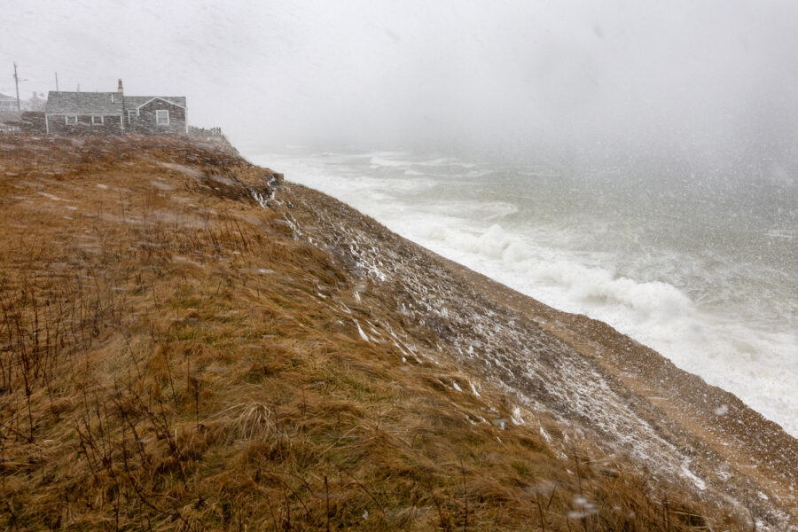 A nor’easter causes large waves to hit a bluff filled with sand to prevent erosion in Nantucket, Mass., on Feb. 13, 2024. Credit: Stan Grossfeld/The Boston Globe via Getty Images