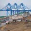 The cranes of a new megaport tower behind the town of Chancay, Peru. Credit: Cris Bouroncle/AFP via Getty Images