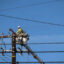 A Pacific Gas and Electric worker replaces power poles destroyed during the Eaton Fire in Altadena, Calif., on Jan. 22. Credit: Sarah Reingewirtz/MediaNews Group/Los Angeles Daily News via Getty Images