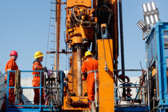 Workers assemble a drill rod on a geothermal drilling rig in Krefeld, Germany. Credit: Roland Weihrauch/picture alliance via Getty Images