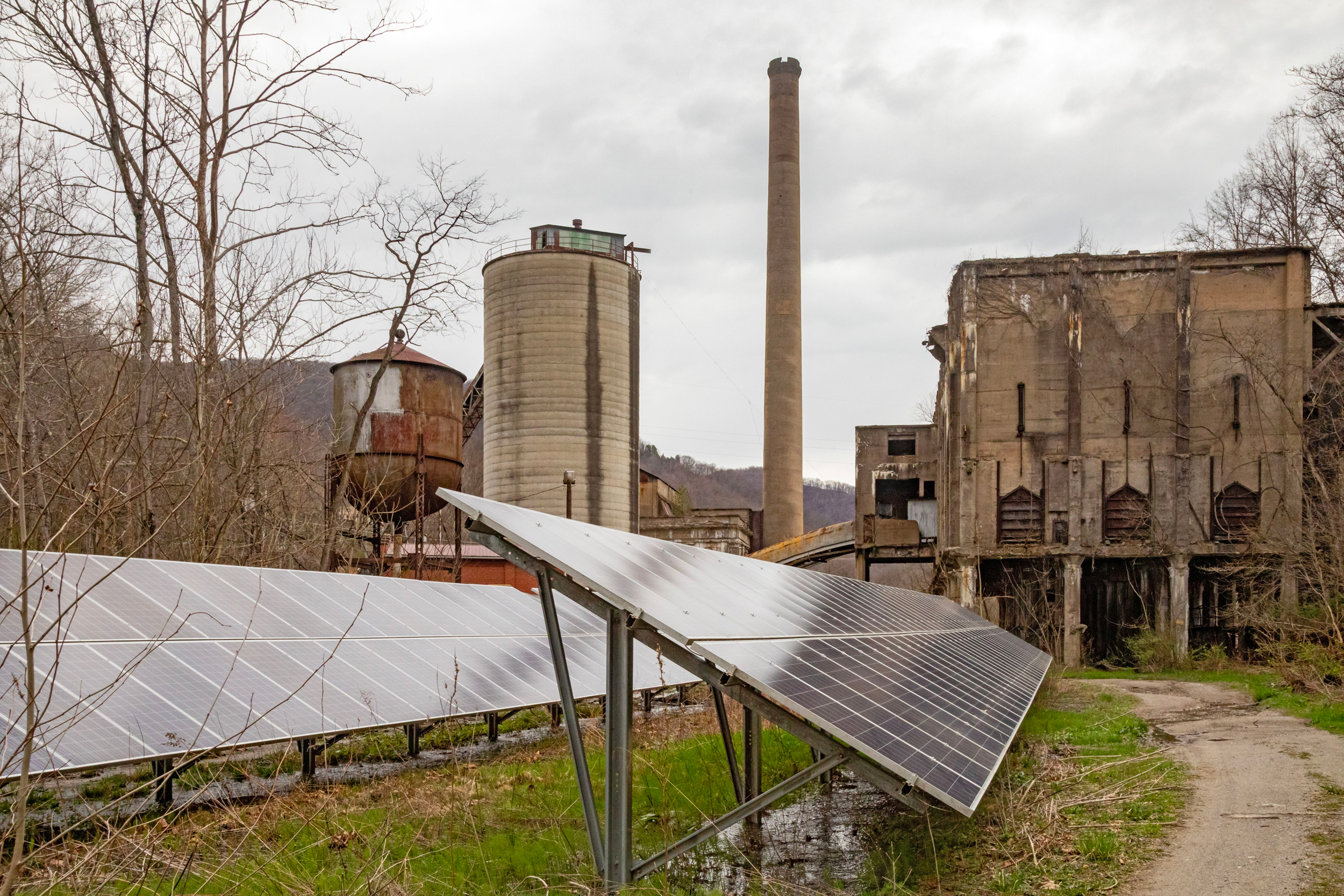 Solar panels stand near the remains of coal mining equipment in Lynch, Ky. Credit: Jim West/UCG/Universal Images Group via Getty Images