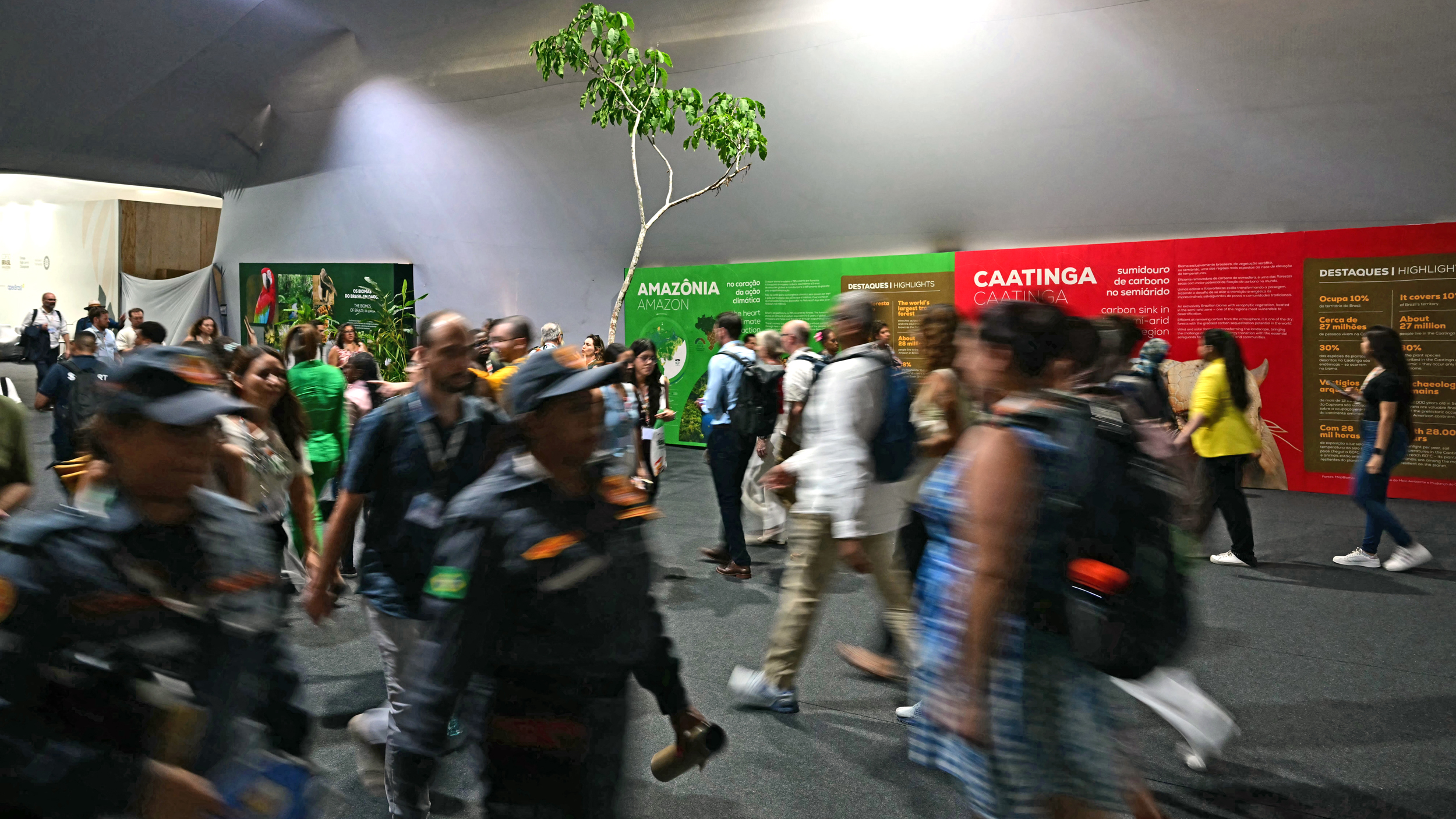 Attendees walk through the hallways of COP30 on Monday in Belém, Brazil. Credit: Pablo Porciuncula/AFP via Getty Images