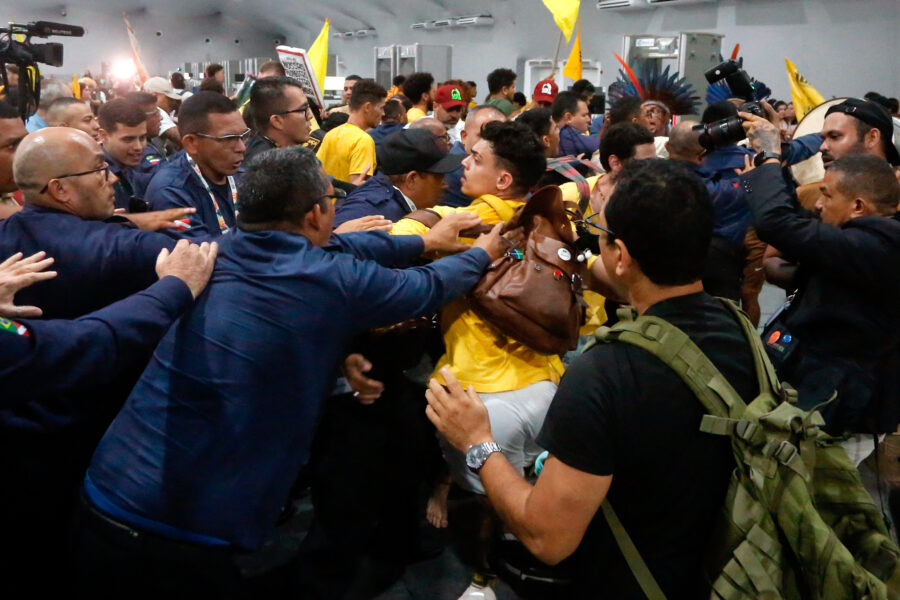Security personnel clash with protesters as they storm the venue during the COP30 climate conference on Tuesday in Belém, Brazil. Credit: Olga Leiria/AFP via Getty Images