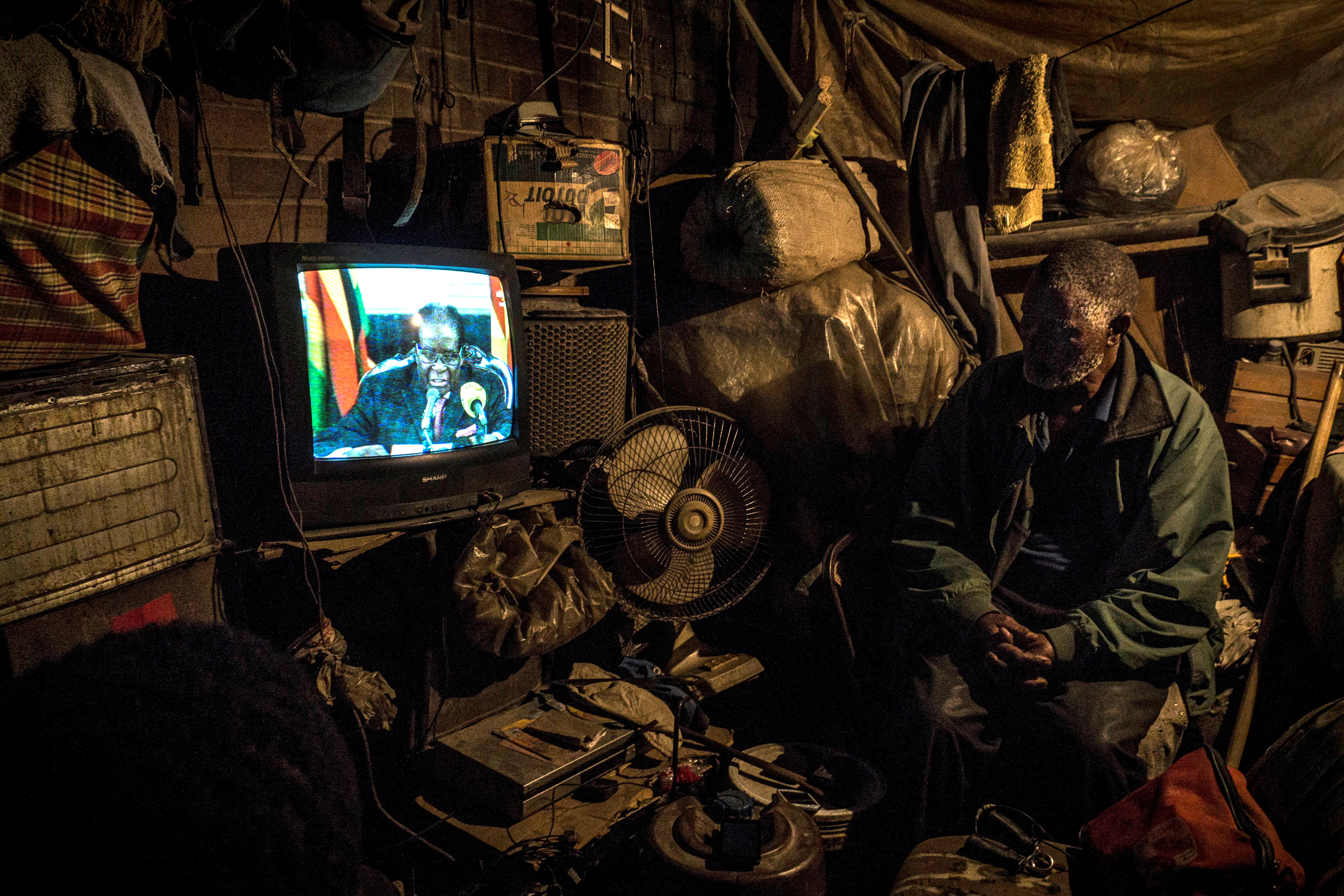 A man watches a broadcast of a state address by Zimbabwe President Robert Mugabe in Harare on Nov. 19, 2017. Zinyange Auntony/AFP via Getty Images