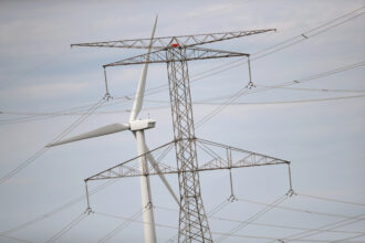 Power lines and a wind turbine rise above the rural landscape of Dwight, Ill. Credit: Scott Olson/Getty Images