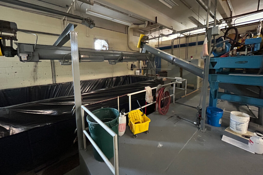 After going through dewatering, sludge is poured into a dumpster to be taken to the Juniper Ridge landfill. Credit: Courtesy of Dan Marks