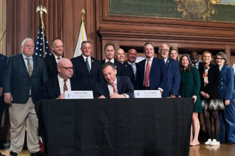 EPA Administrator Lee Zeldin (center) signs a proposed rule in Washington, D.C., on Monday that would revise the definition of “waters of the United States,” scaling back which bodies of water are subject to federal protections. Credit: Aidan Hughes/Inside Climate News