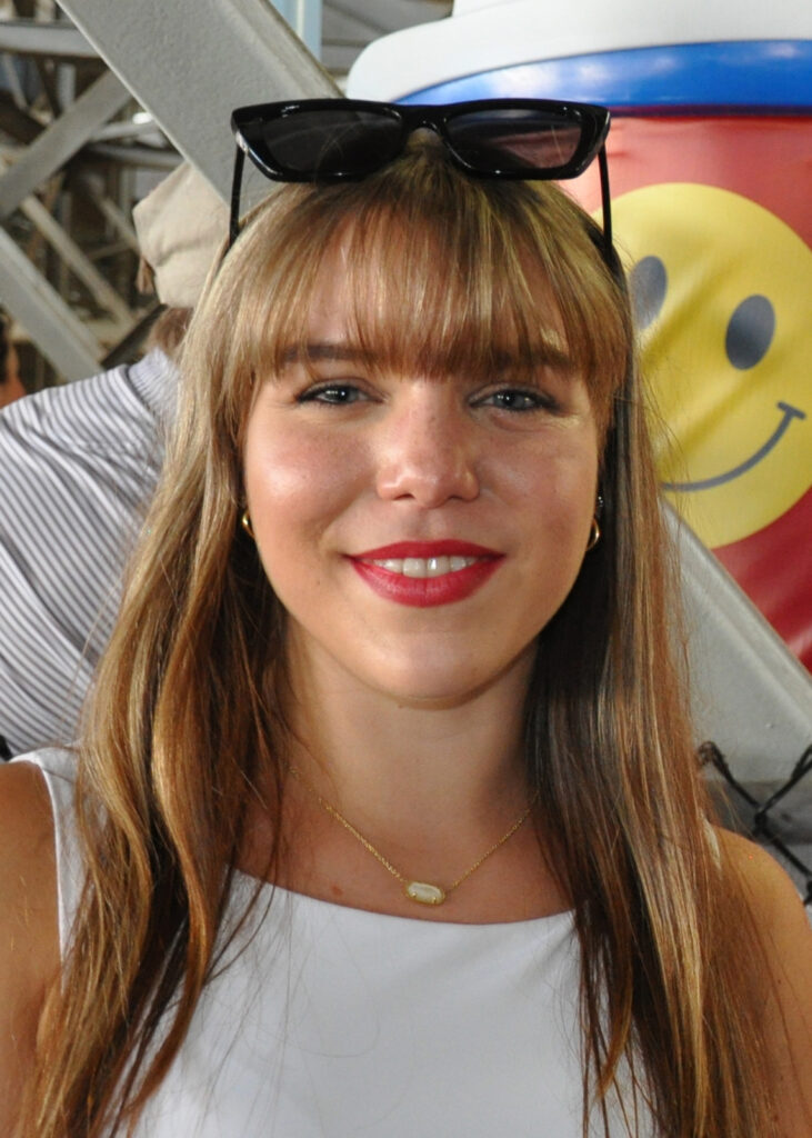 University of Alabama graduate student Izzy Piper poses for a photo as she waits for water at a cooling station. Credit: Olivia McMurrey/Inside Climate News