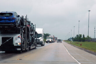Semi-trucks drive on the highway next to the CenterPoint Intermodal Center in Elwood, Ill. Credit: Siri Chilukuri/Inside Climate News