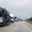 Semi-trucks drive on the highway next to the CenterPoint Intermodal Center in Elwood, Ill. Credit: Siri Chilukuri/Inside Climate News