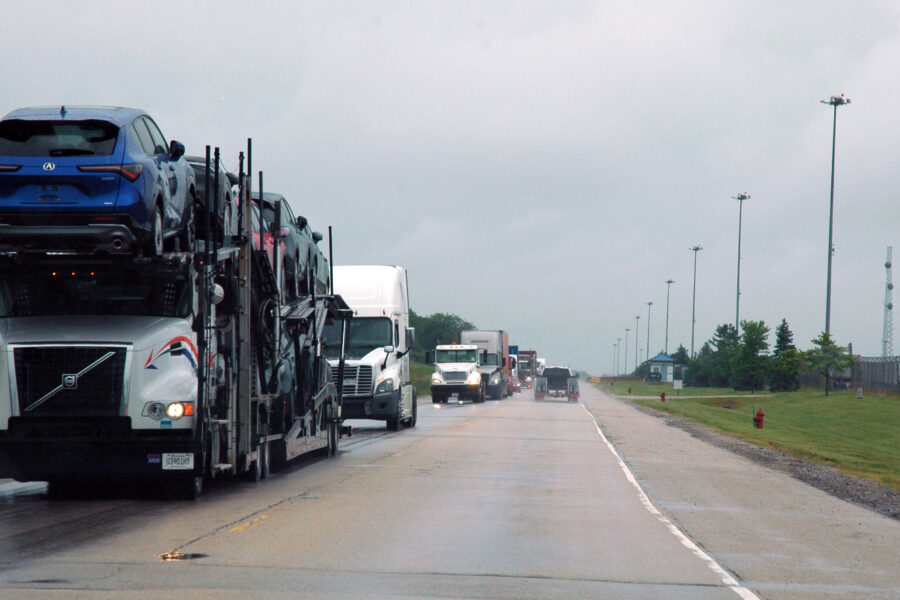 Semi-trucks drive on the highway next to the CenterPoint Intermodal Center in Elwood, Ill. Credit: Siri Chilukuri/Inside Climate News