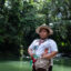 Zuly Rivera, a water defender and youth coordinator for the Nasa pueblo, stands at the Caliyacu River in Mocoa, Colombia.