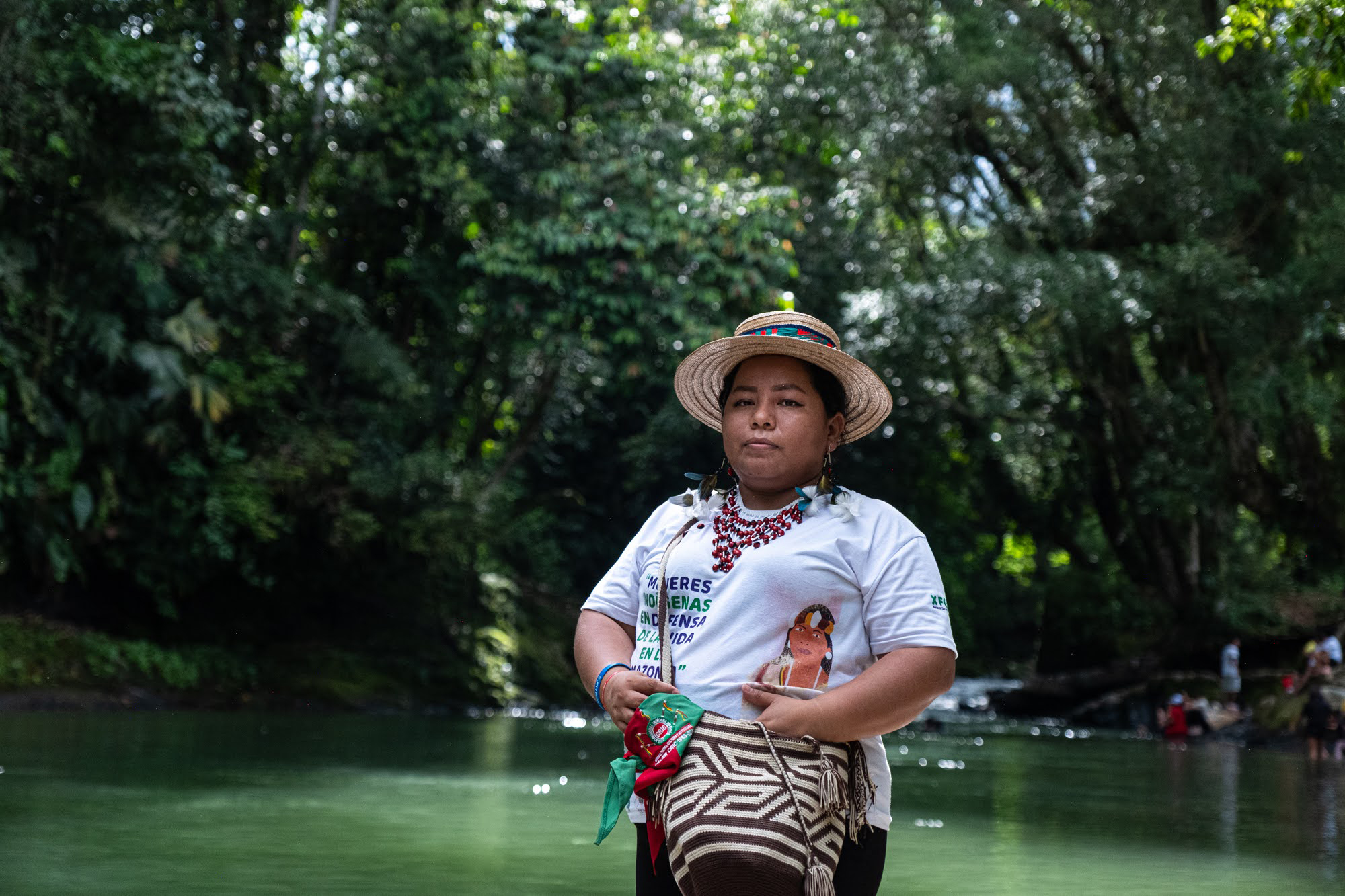 Zuly Rivera, a water defender and youth coordinator for the Nasa pueblo, stands at the Caliyacu River in Mocoa, Colombia.