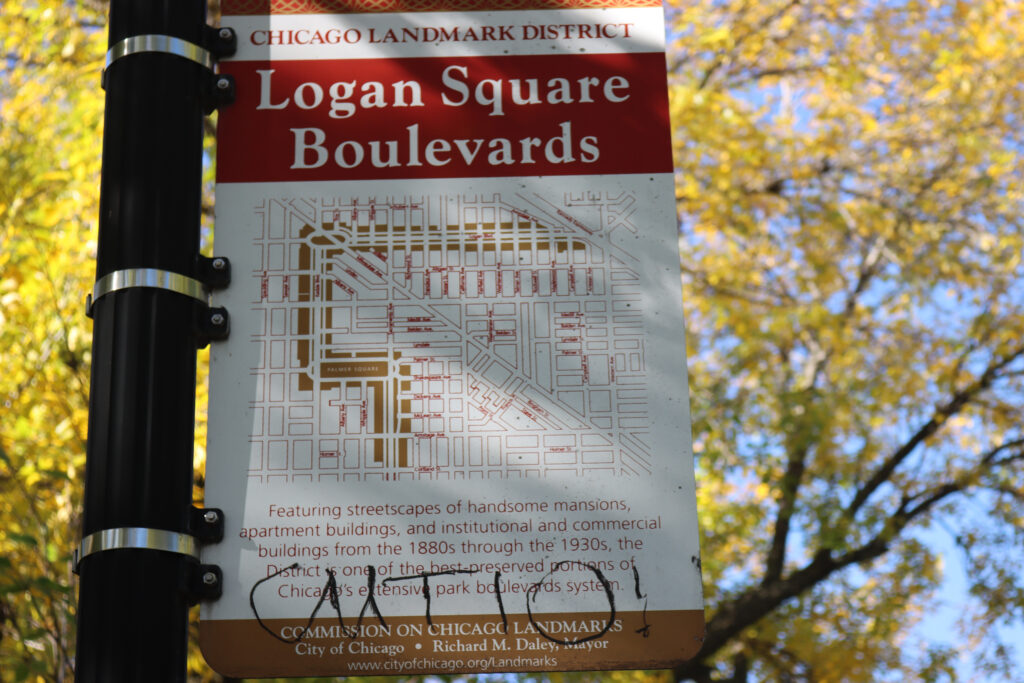 Informational signs like this one in Logan Square celebrate the neighborhood’s well-kept historic boulevards. Credit: Yiannis Mastoras/Inside Climate News