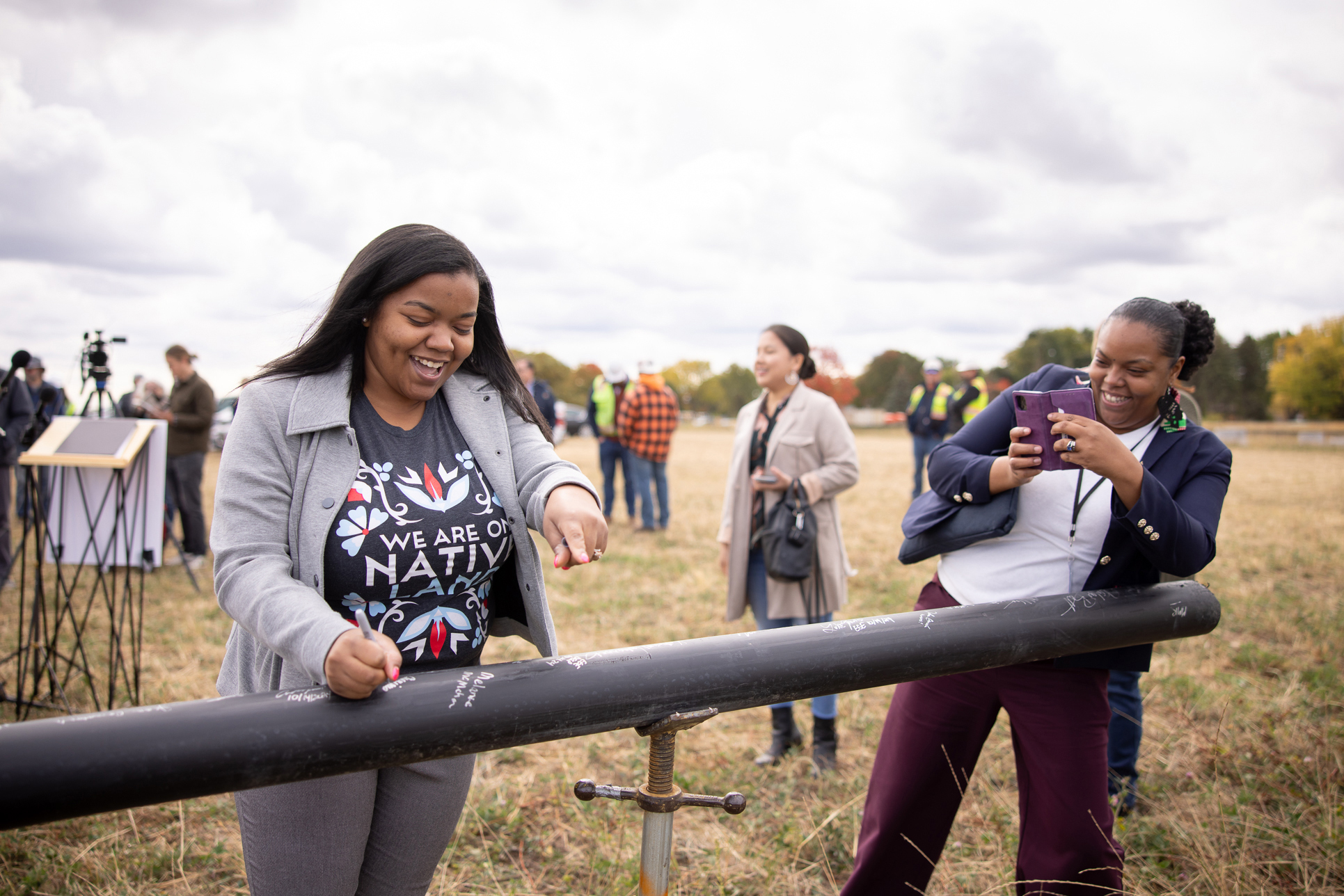 Cheniqua Johnson, a St. Paul city councilmember and Saint Paul Port Authority treasurer, signs a geothermal pipe at The Heights groundbreaking event in October 2024. Credit: District Energy St. Paul