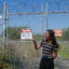 Luna Angulo, born and raised in Richmond, Calif., stands in front of a site where long-defunct chemical plants dumped toxic wastes, near another hazardous site likely to flood as sea level rises along the city’s shoreline. Credit: Liza Gross/Inside Climate News