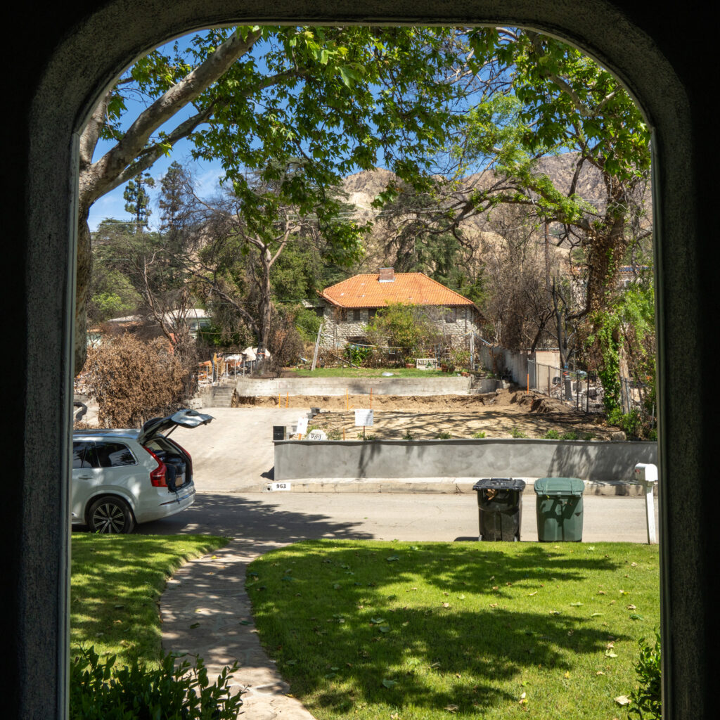 The view from the Valdez-Perera family’s front door now looks out at an empty lot where her neighbor’s house once stood.