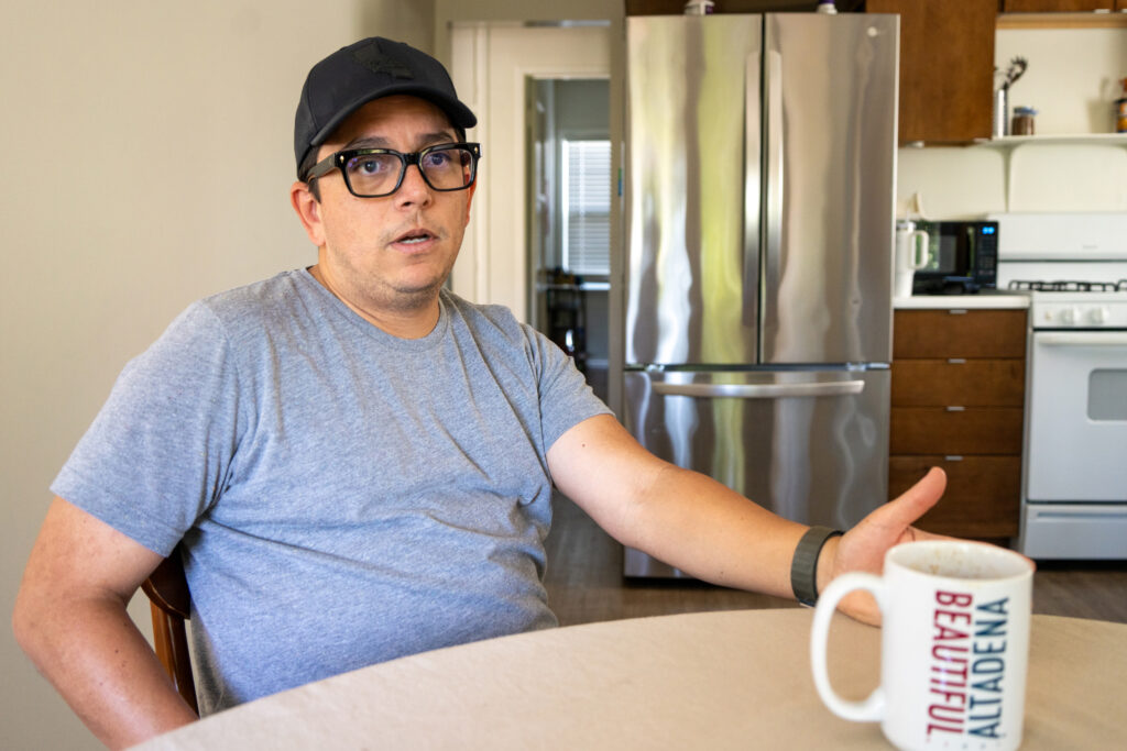 Manfred Perera talks about the Eaton Fire at the kitchen table in the family’s rental house on April 7.