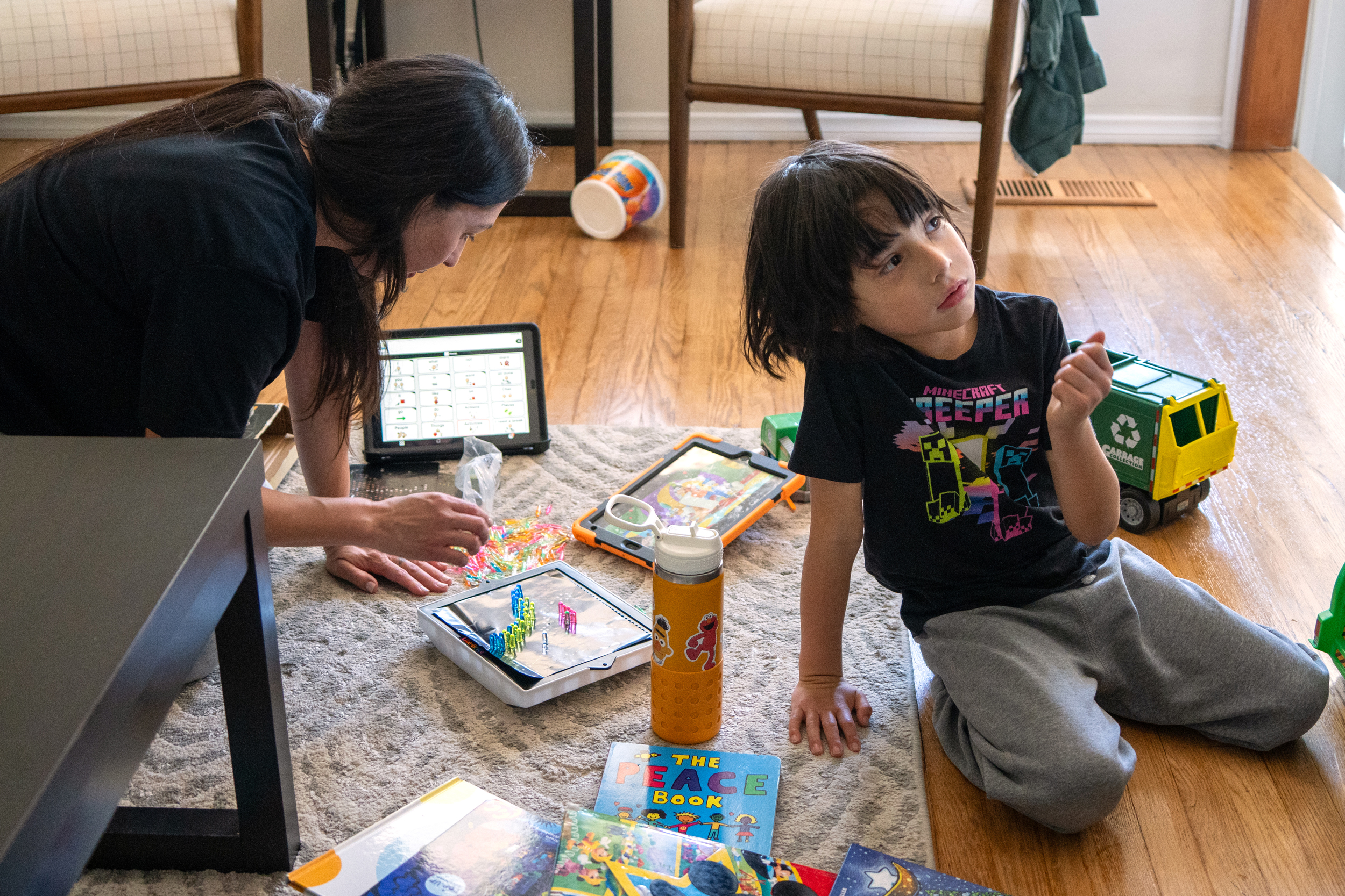 Adriana Valdez and her son, Max, play in their living room on April 7.