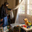 Adriana Valdez pulls back a drape to inspect the layer of ash coating her son’s toys at her home in Altadena on April 1.