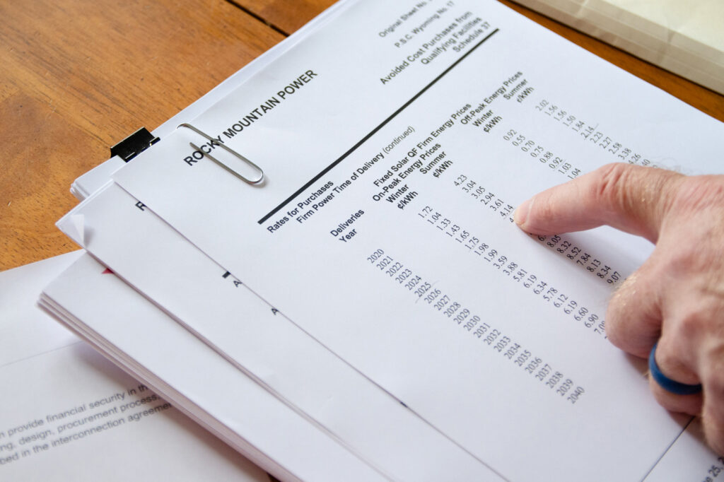 Teichert looks over his power purchase agreement with Rocky Mountain Power. He is forgoing the agreement because he doesn’t believe it will ever let him recoup the costs of his system.
