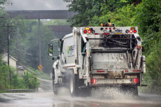 A truck for Noble Environmental, the parent company of Westmoreland Sanitary Landfill in Belle Vernon, Pa., drives down a road on a rainy day. Credit: Scott Goldsmith/Inside Climate News