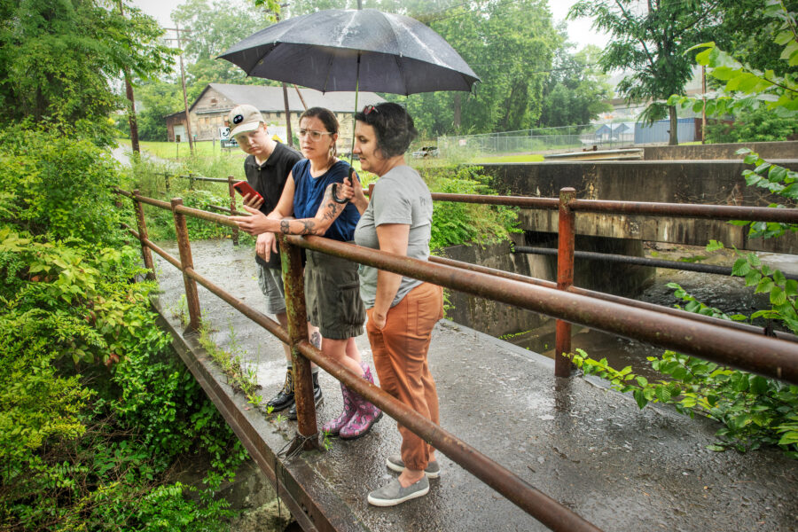 Yvonne Sorovacu (right), Hannah Hohman (center) and Jay Beal monitor a creek for signs of contamination from the Westmoreland Sanitary Landfill in Belle Vernon, Pa.