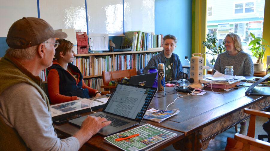 From left: Scott Vlaun, Renee Igo, Tamra Benson and Ania Wright talk around a table at the Center for an Ecology-Based Economy in Norway, Maine. Credit: Sydney Cromwell/Inside Climate News