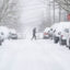 A jogger makes their way across a snowy street after a winter storm hit Seattle on Feb. 13, 2021. Credit: David Ryder/Getty Images
