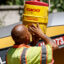 A Los Angeles County crew member hydrates between repaving a road as temperatures reach 100 degrees and above in August 2023. Credit: Robert Gauthier/Los Angeles Times via Getty Images