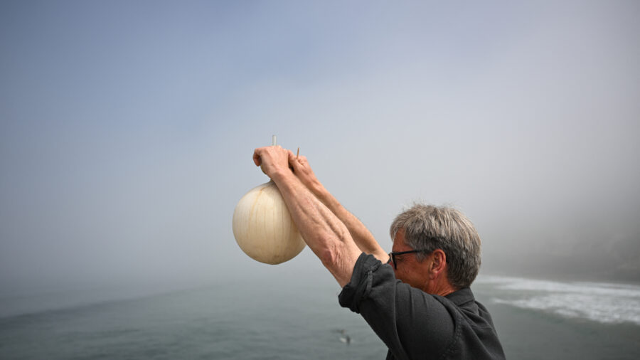 Professor Ralph Keeling, son of Charles David Keeling, demonstrates how a sample of air is collected to measure carbon dioxide in the atmosphere on April 11 as part of the Keeling Curve monitoring study at the UC San Diego Scripps Institution of Oceanography. Credit: Patrick T. Fallon/AFP via Getty Images)