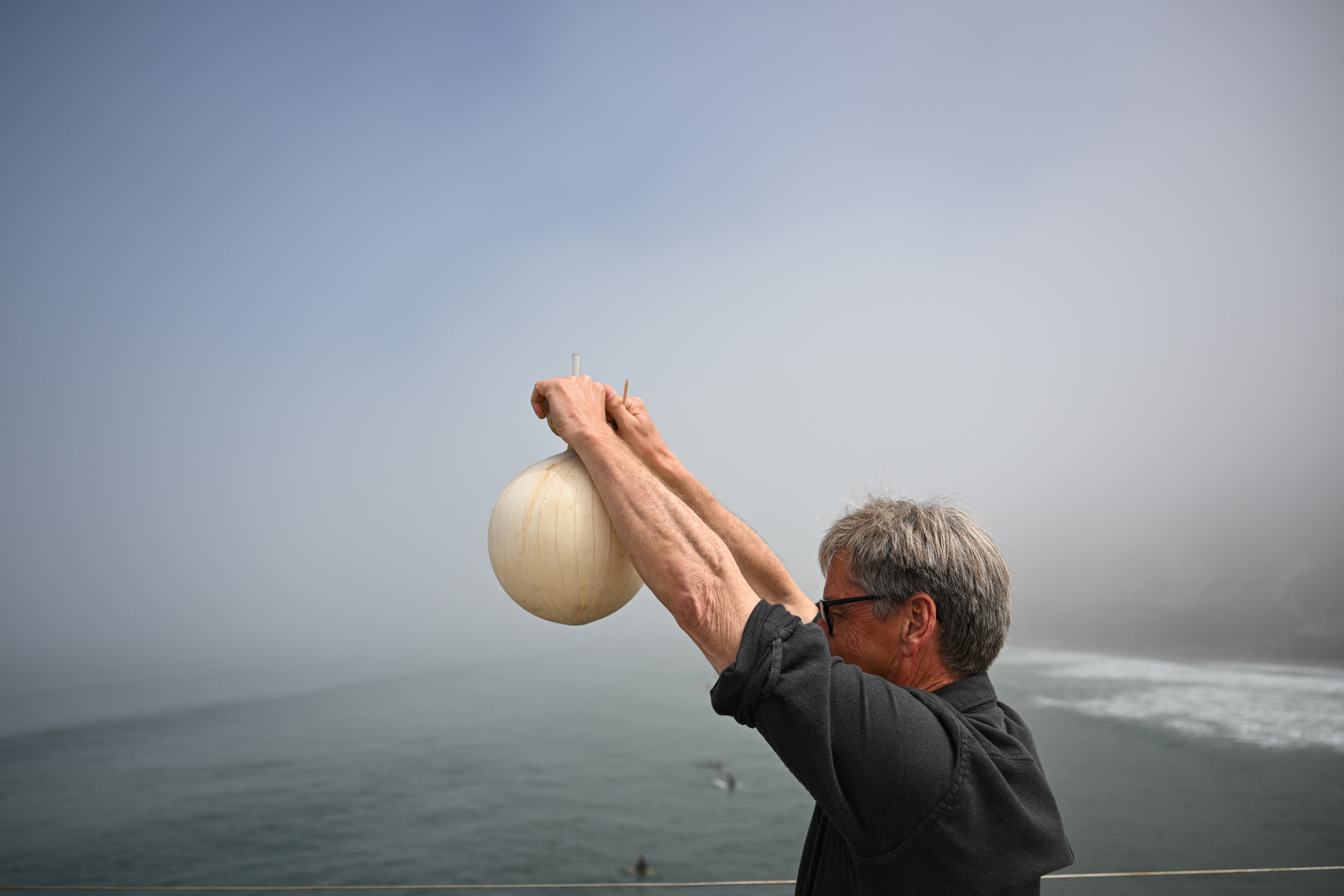Professor Ralph Keeling, son of Charles David Keeling, demonstrates how a sample of air is collected to measure carbon dioxide in the atmosphere on April 11 as part of the Keeling Curve monitoring study at the UC San Diego Scripps Institution of Oceanography. Credit: Patrick T. Fallon/AFP via Getty Images)