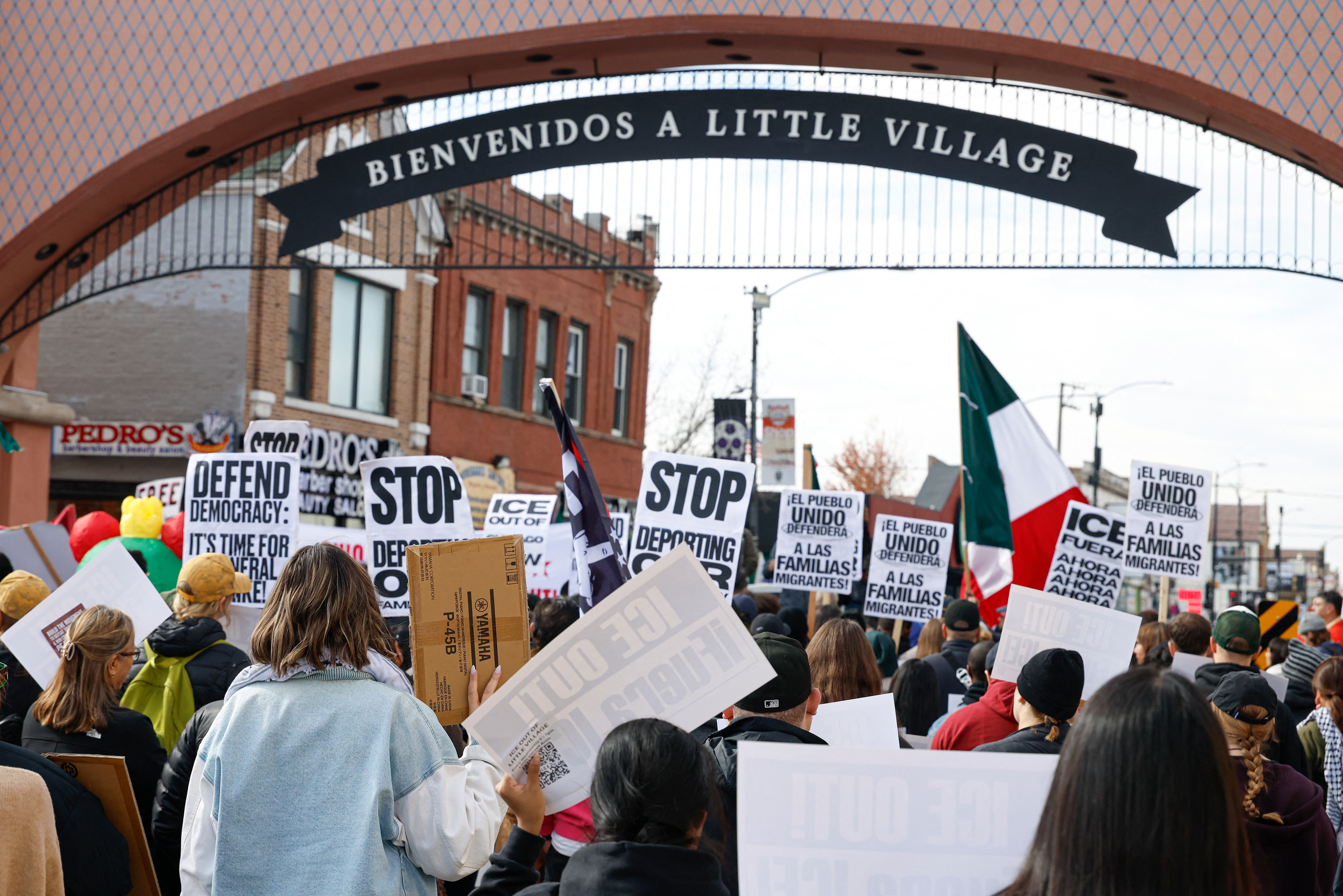 Protesters hold signs against ICE during a demonstration at the predominantly Mexican-American neighborhood of Little Village in Chicago on Oct. 25. Credit: Kamil Krzaczynski/AFP via Getty Images