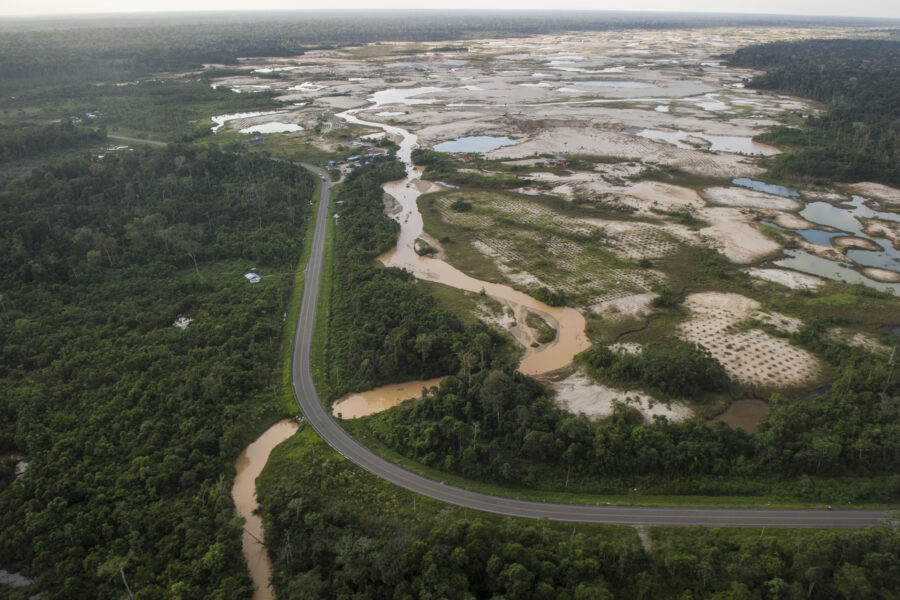 The Interoceanic Highway runs by an illegal gold mining site in La Pampa, Peru. Credit: Ernesto Benavides/AFP via Getty Images