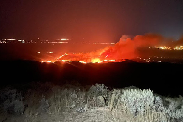 The Valley Fire, as seen looking down from the top of Lucky Peak, burns in the early morning before dawn. Credit: Heather Hayes