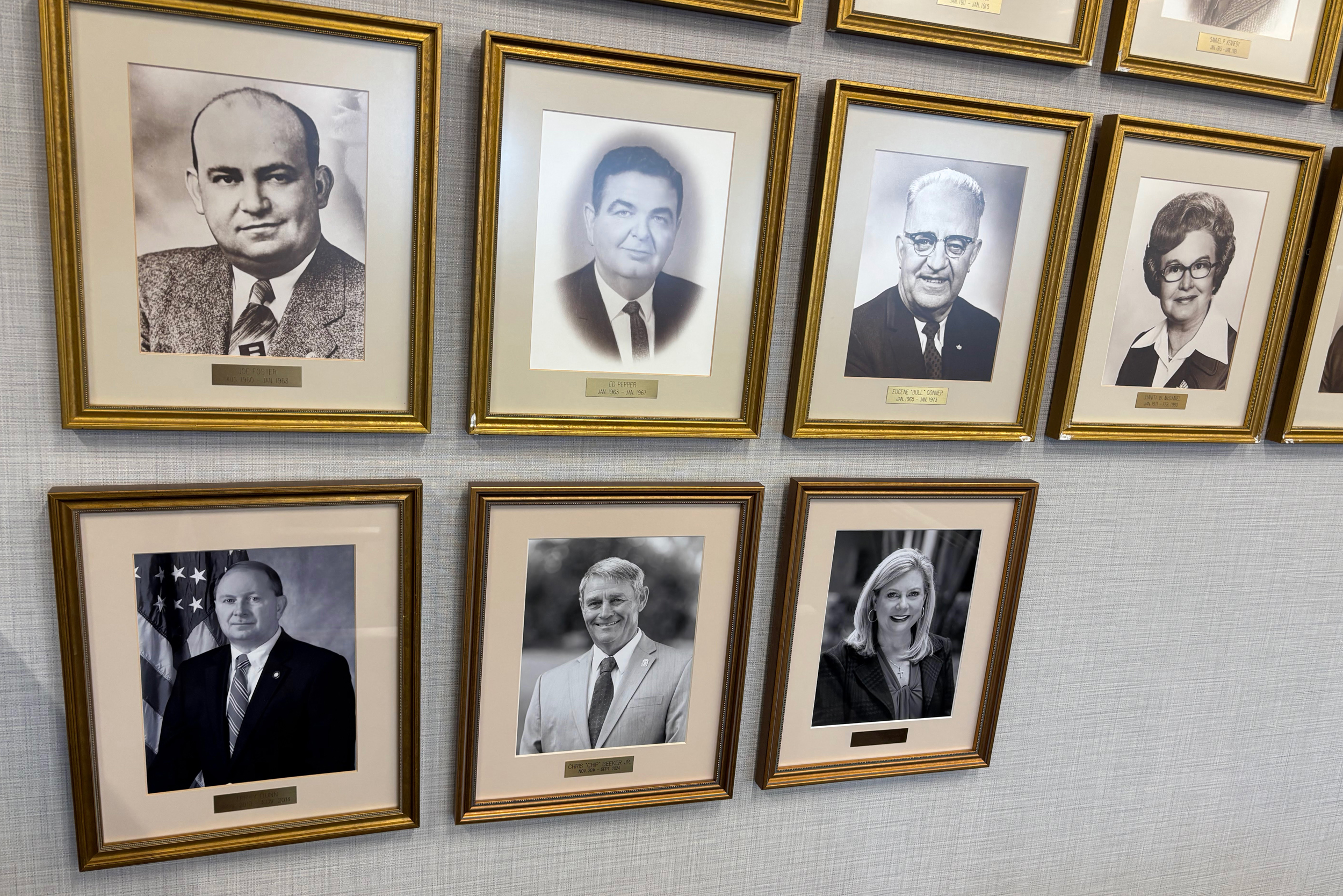 Photos of prior Alabama Public Service Commissioners dating back to 1881 hang on the wall of the Carl L. Evans Chief Administrative Law Judge Hearing Complex at the RSA Union Building in Montgomery. The PSC hosts formal and informal meetings in the complex. Credit: Dennis Pillion/Inside Climate News